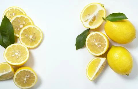 Lemons placed on a white background with copy space and cut in half Stock Photos