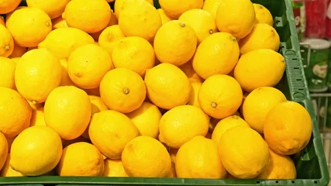Lemons rest on shelf at the store, vibrant and fresh. Explore the citrusy Stock Footage 268979873