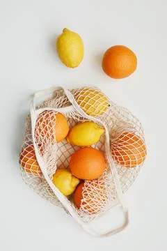 Lemons in reusable bag. Zero waste concept with string bag, mesh bag, grosery Stock Photos