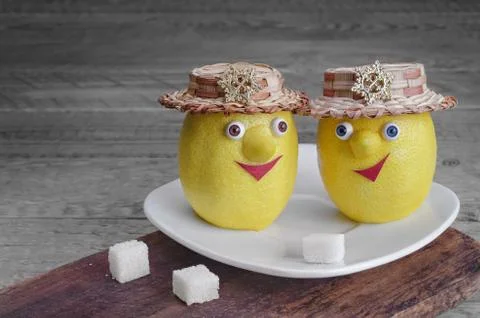 Lemons with sugar on a white plate and grey wooden background 写真素材