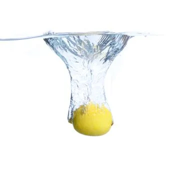 Lemons in the water with bubbles and splashes. Close-up. Isolated on white.Co Stock Photos