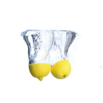 Lemons in the water with bubbles and splashes. Close-up. Isolated on white.Co Stock Photos