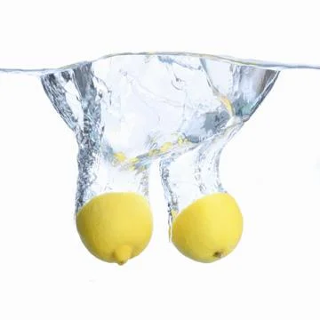 Lemons in the water with bubbles and splashes. Close-up. Isolated on white.Co Stock Photos