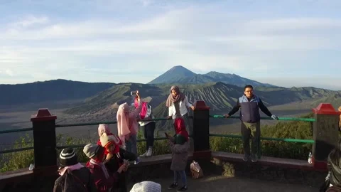Lengthy Shot of Tourists posing in front of Mount Bromo, Java, Indonesia Stock Footage 131152599