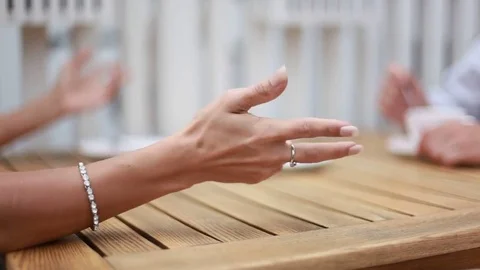 Lengthy wave gestures women's hands at the table and falling Cup - close-up Stock Footage
