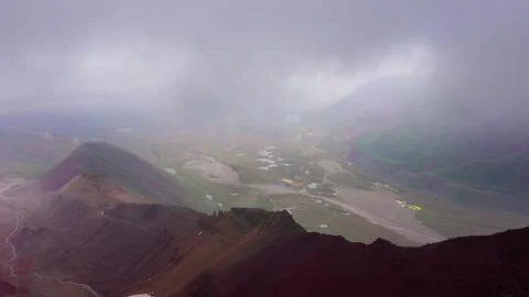 Lenin Peak Base camp yellow tents stand green meadow at 3600m with panoramic vi Video stock 320439890