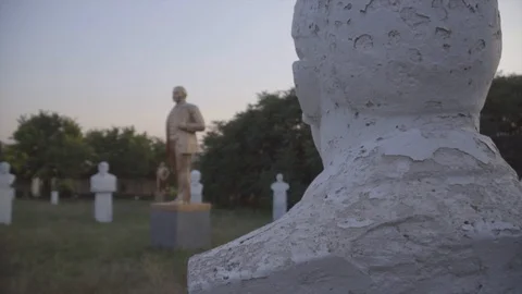 Lenin statues and busts in open-air museum of the Soviet period on sunset Stock Footage 94955184