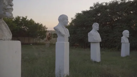 Lenin statues and busts in open-air museum of the Soviet period on sunset Stockbeeldmateriaal 106244715