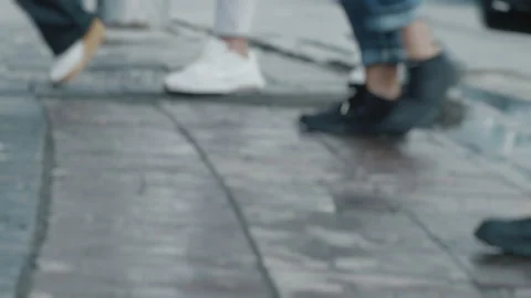 Lens blur, out of focus. A crowd of pedestrians crossed the road on wet asphalt Stock-Footage 141990908