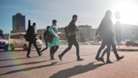 Lens blur, out of focus. A crowd of pedestrians is walking along the street with Stock Footage 143732441