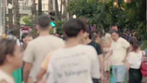 Lens blur, out of focus. a crowd of pedestrians are walking along the street Stock Footage 204850950