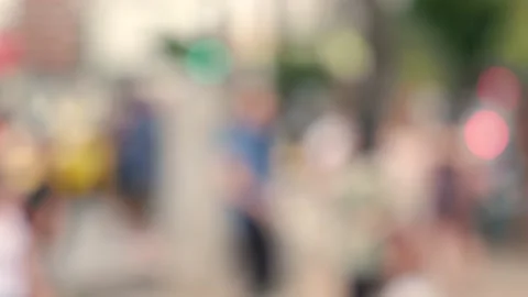 Lens blur, out of focus. a crowd of pedestrians are walking along the street Stock Footage 204850980