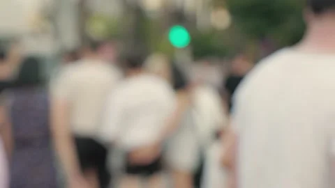 Lens blur, out of focus. a crowd of pedestrians are walking along the street Stock Footage 204966993