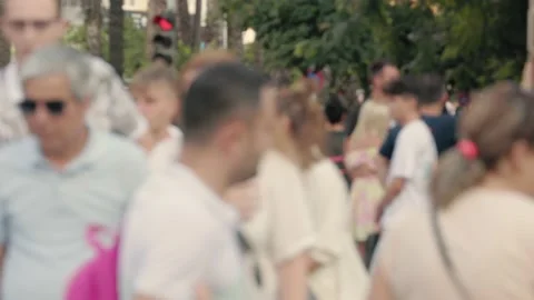 Lens blur, out of focus. a crowd of pedestrians are walking along the street Stock Footage 204967100