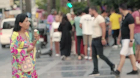 Lens blur, out of focus. a crowd of pedestrians are walking along the street Stock Footage 204967169
