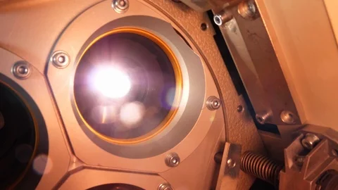 The lens of a cinema projector in a movie theater - close up view Stock Footage 93583710