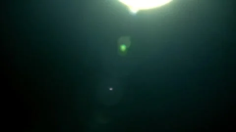 Lens Flare Effect Moving Across Black Background 動画素材 303914893