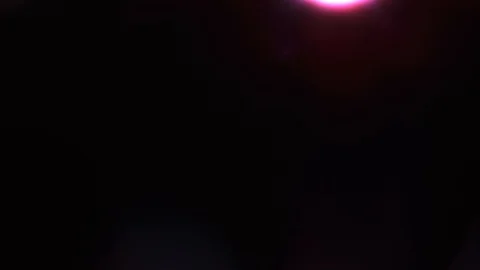 Lens flare light and bright glow over black background. Vertical flares movement Stock Footage 122752873
