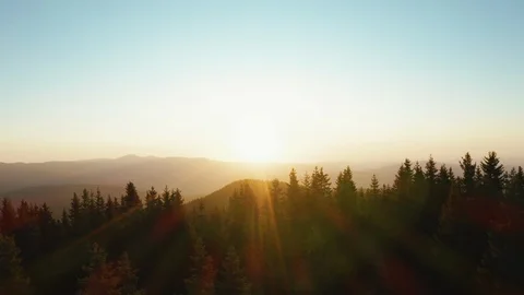 Lens flare in mountains at orange sunset in summer morning aerial view drone Stock Footage 123724221