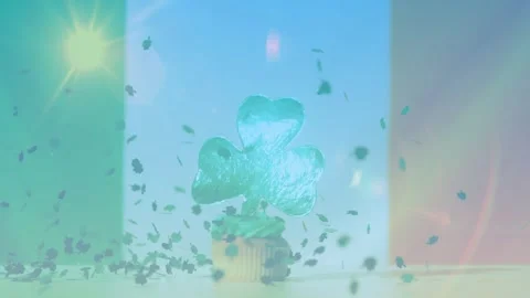 Lens flare pulsing, causing confetti falling over clover cupcake, settling, Stock Footage 329835222
