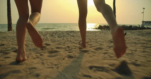Lens flare, Slow motion: Close up Women friends running enjoy life Stock Footage 123641263
