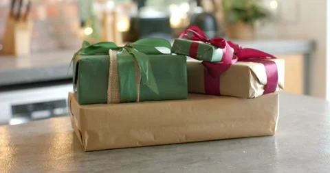 Lens focus shift is revealing three gift boxes on kitchen countertop to Stock Footage 335683005