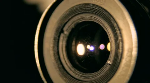 Lens of old retro style camera rounding in the dark in the lights studio Stock Footage 64854851