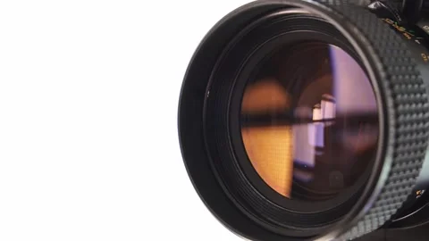 Lens of vintage Super 8 movie camera on white background.Old film camera.Close Vidéo 313537672