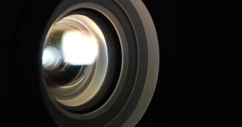 The lens of a working projector. Cinema 4K 60fps zoom-in video Stock Footage 282660538