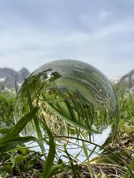 Lensball with grass reflections in the Austrian Alps. Stock Photos
