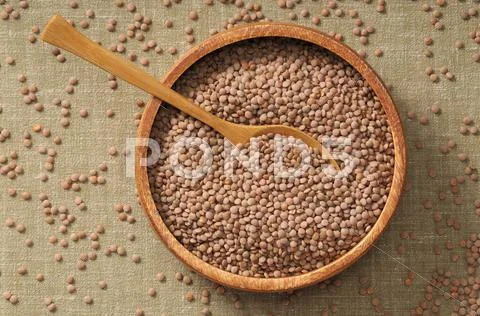 Lentils In A Bowl With A Wooden Spoon