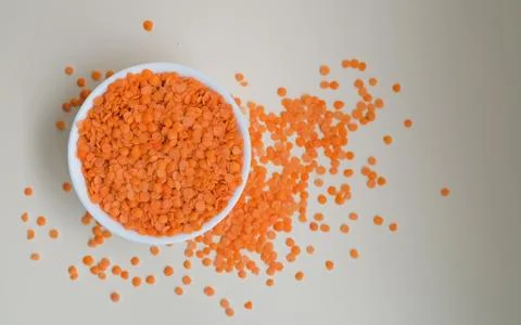 Lentils in a cup on a light background Stock Photos