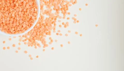 Lentils in a cup on a light background Stock Photos
