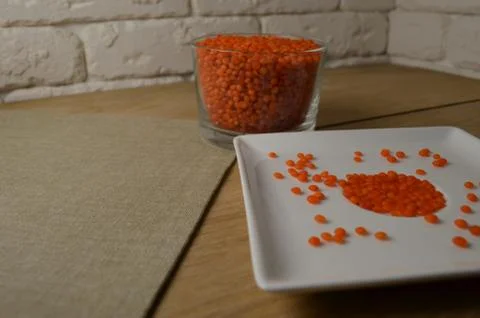 Lentils in the dishes on the table. Stock Photos
