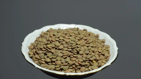 Lentils. Heap of raw uncooked brown lentils Stock Footage 102411225
