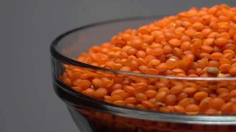 Lentils. Heap of raw uncooked red lentils in bowl. Video stock 102459955