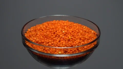 Lentils. Heap of raw uncooked red lentils in bowl. Video stock 102460337