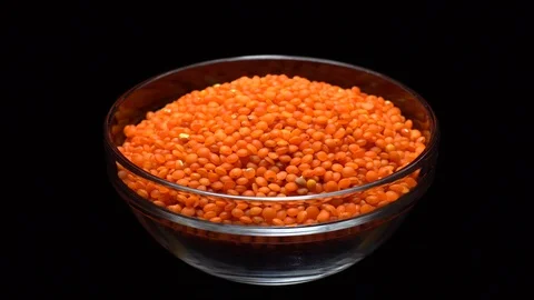 Lentils. Heap of raw uncooked red lentils in bowl in rotation. Stock Footage 102461150
