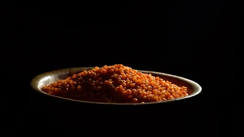 Lentils. Heap of raw uncooked red lentils in bowl in rotation. Video stock 102461732