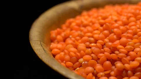 Lentils. Heap of raw uncooked red lentils in bowl in rotation. Video stock 102462068