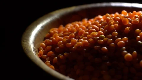 Lentils. Heap of raw uncooked red lentils in bowl in rotation. Video stock 102462076