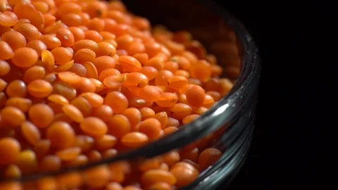 Lentils. Heap of raw uncooked red lentils in bowl in rotation. Video stock 102462078