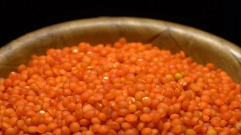 Lentils. Heap of raw uncooked red lentils in bowl in rotation. Stock Footage 102462653
