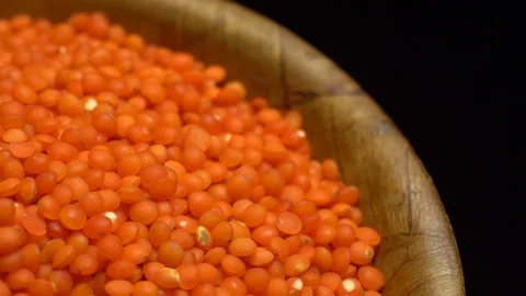 Lentils. Heap of raw uncooked red lentils in bowl in rotation. Stock Footage 102462763