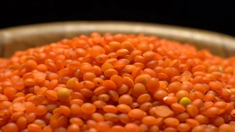 Lentils. Heap of raw uncooked red lentils in bowl in rotation. Video stock 102462927