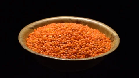 Lentils. Heap of raw uncooked red lentils in bowl in rotation. Stock Footage 102463245