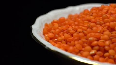 Lentils. Heap of raw uncooked red lentils in bowl in rotation. Stock Footage 102478787