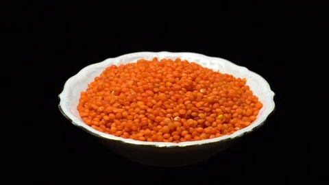 Lentils. Heap of raw uncooked red lentils in bowl in rotation. Stock Footage 102478831