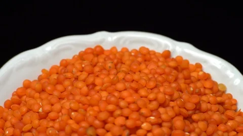 Lentils. Heap of raw uncooked red lentils in bowl in rotation. Stock Footage 102478840
