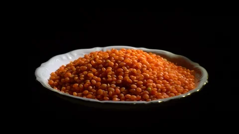 Lentils. Heap of raw uncooked red lentils in bowl in rotation. Stock Footage 102478956